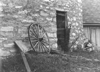 SA0741.31 - Photo of carriage wheel against side of round barn.
